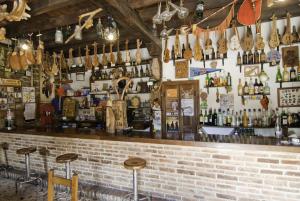 a bar with a brick wall and lots of bottles at Posada Casa Molleda in Pejanda