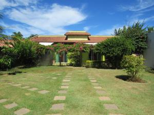 um jardim em frente a uma casa em Pousada Mangas em Manguinhos