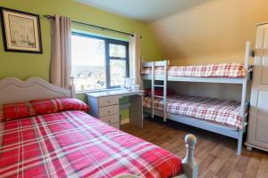 a bedroom with two bunk beds and a window at Lakeland House in Cong