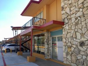 a building with a staircase on the side of it at Oasis Motel in Arlington