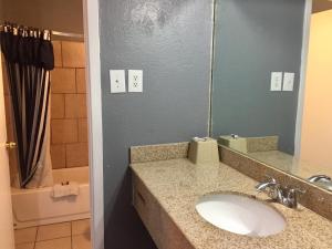 a bathroom with a sink and a mirror at Oasis Motel in Arlington +26 photos
