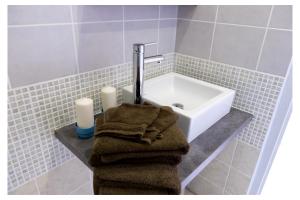 a bathroom with a sink and a towel on a counter at Domaine de la Grange aux Dîmes in Feux +8 photos