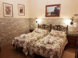 Säng eller sängar i ett rum på Hotel Il Casolare