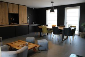 a kitchen and dining room with a table and chairs at La Couture du Charme in Saméon