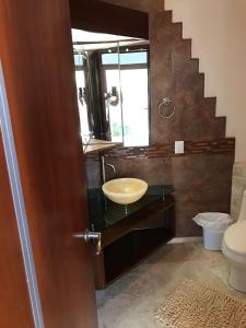 a bathroom with a sink and a mirror at Casa Bonita cerca de playa in Bucerías