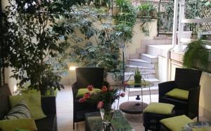 a patio with plants and chairs and a table at InnVatican Guest House in Rome