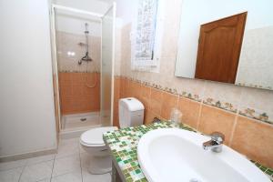 a bathroom with a toilet and a sink and a mirror at Chambres d'hôtes Multari in Patrimonio