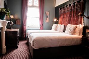 a bedroom with a large bed and a window at Half Moon in London