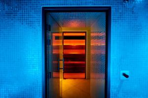 a hallway with a door in a blue room at Harbour Hotel & Spa Bristol in Bristol +19 photos
