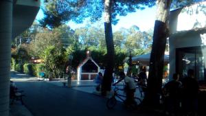 a group of people sitting outside a building at VIOLA Club Village & Camping in Foce Varano