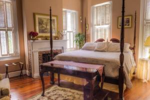 a bedroom with a bed and a fireplace at Olde Town Inn in Augusta
