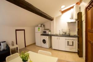 a kitchen with white appliances and a table with chairs at Estudio Sto. Tomas, Haro in Haro