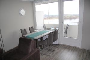 a dining room with a table and chairs and a window at Seeblick Bad Segeberg in Bad Segeberg