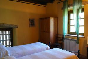 a bedroom with two beds and a window at B&B Ai Chiosi in Pontremoli