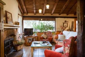 a living room with a couch and a fireplace at Casa Rural la Casa del Bosque in Navaconcejo