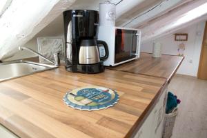 a kitchen counter with a coffee maker and a plate on it at Buhardilla Corazon de Malasana in Madrid