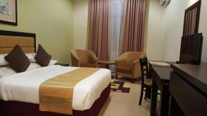 Postel nebo postele na pokoji v ubytování Puteri Bay Hotel