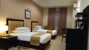 Postel nebo postele na pokoji v ubytování Puteri Bay Hotel