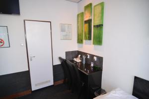 TV a/nebo společenská místnost v ubytování Hotel Bienvenue