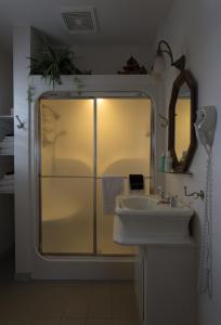 
a bathroom with a sink, mirror and toilet at Stewart Inn in Wausau
