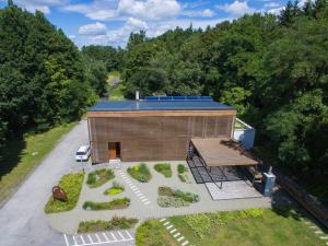 an overhead view of a building with a solar roof at Macskakő Vendégház in Somoskőújfalu