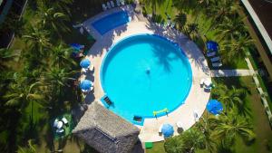 an overhead view of a large swimming pool with palm trees at Beach Break Resort in Jacó
