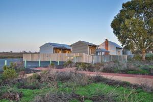 a row of houses on the side of a river at Mungo Shearers' Quarters in Mungo