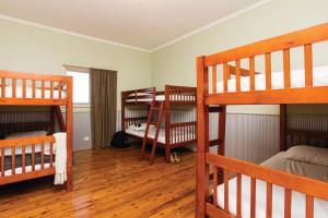 a room with three bunk beds in a room at Mungo Shearers' Quarters in Mungo