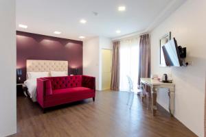 a bedroom with a red chair and a bed at Aloha Hotel SDN BHD in Pontian Kecil +33 photos