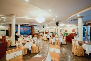a restaurant with tables and people sitting at them at Grand Hotel Vung Tau in Vung Tau
