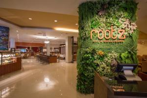 a large wall of ivy in a shopping mall at Guam Plaza Resort in Tumon +125 photos