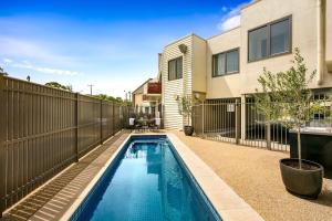 a swimming pool in the backyard of a house at Quest Bendigo Central in Bendigo
