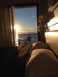 a bedroom with a bed and a view of the ocean at Villa Azur in Villeneuve-Loubet