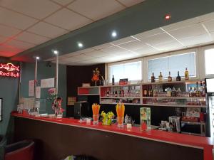 a bar in a restaurant with a red counter at Penzion Maja in Martin