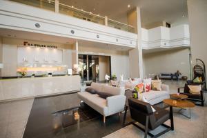 a lobby with couches and chairs in a store at Fortune Hotel Korat- SHA Plus in Nakhon Ratchasima
