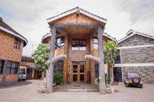 a house with a wooden entrance to it at Hotel Genevieve in Nakuru