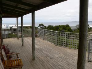 a porch with a view of the ocean at Lantauanan - The Lookout in Island Beach