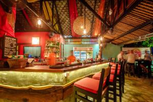 a bar in a restaurant with people sitting at tables at Secret Garden Beach Resort in Bangrak Beach