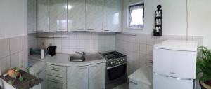 a small kitchen with a stove and a sink at Ivanka Apartment in Kaštela