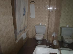 a bathroom with two toilets and a sink at Hostal San Jorge in Zaragoza