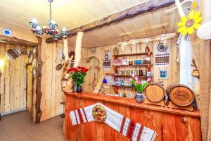 a bar in a room with wooden walls at Gutsulska rodzynka in Yaremche +17 photos
