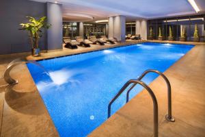 a swimming pool in a hotel with chairs around it at Lionel Hotel Istanbul in Istanbul