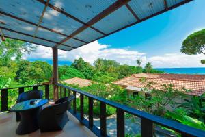 a balcony with a view of the ocean at Sita Beach Resort in Ko Lipe