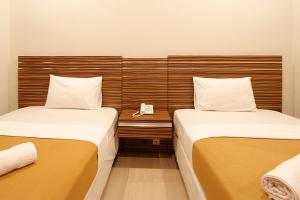 Postel nebo postele na pokoji v ubytování Palapa Hotel