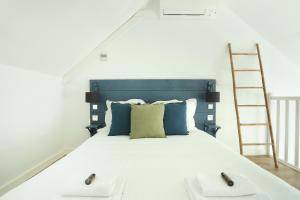 a bedroom with a large bed with a ladder at Les Lilas Serviced Apartments in Les Lilas