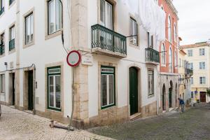 a sign on the side of a building on a street at Severa Apartments in Lisbon