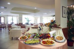 a buffet of food on a table in a restaurant at Hotel Portonuovo in Vieste