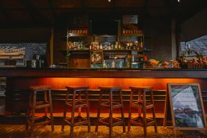 a bar with four stools in a restaurant at Sita Beach Resort in Ko Lipe