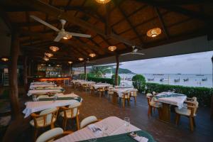 a restaurant with tables and chairs with a view of the ocean at Sita Beach Resort in Ko Lipe