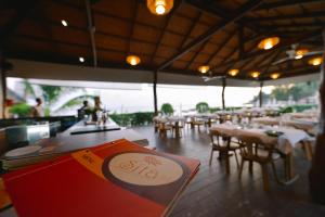 a restaurant with tables and chairs and a menu at Sita Beach Resort in Ko Lipe